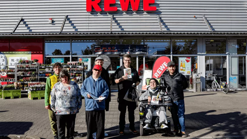 Offizielle Übergabe der Mosaik-Einkaufshilfe an Rewe-Marktmanager Martin Nothelle (Mitte); mit dabei: Projektverantwortlicher Jan Wiemer, BFB-Leiter Thomas Franke und Teilnehmendes des BFB Werbellinstraße